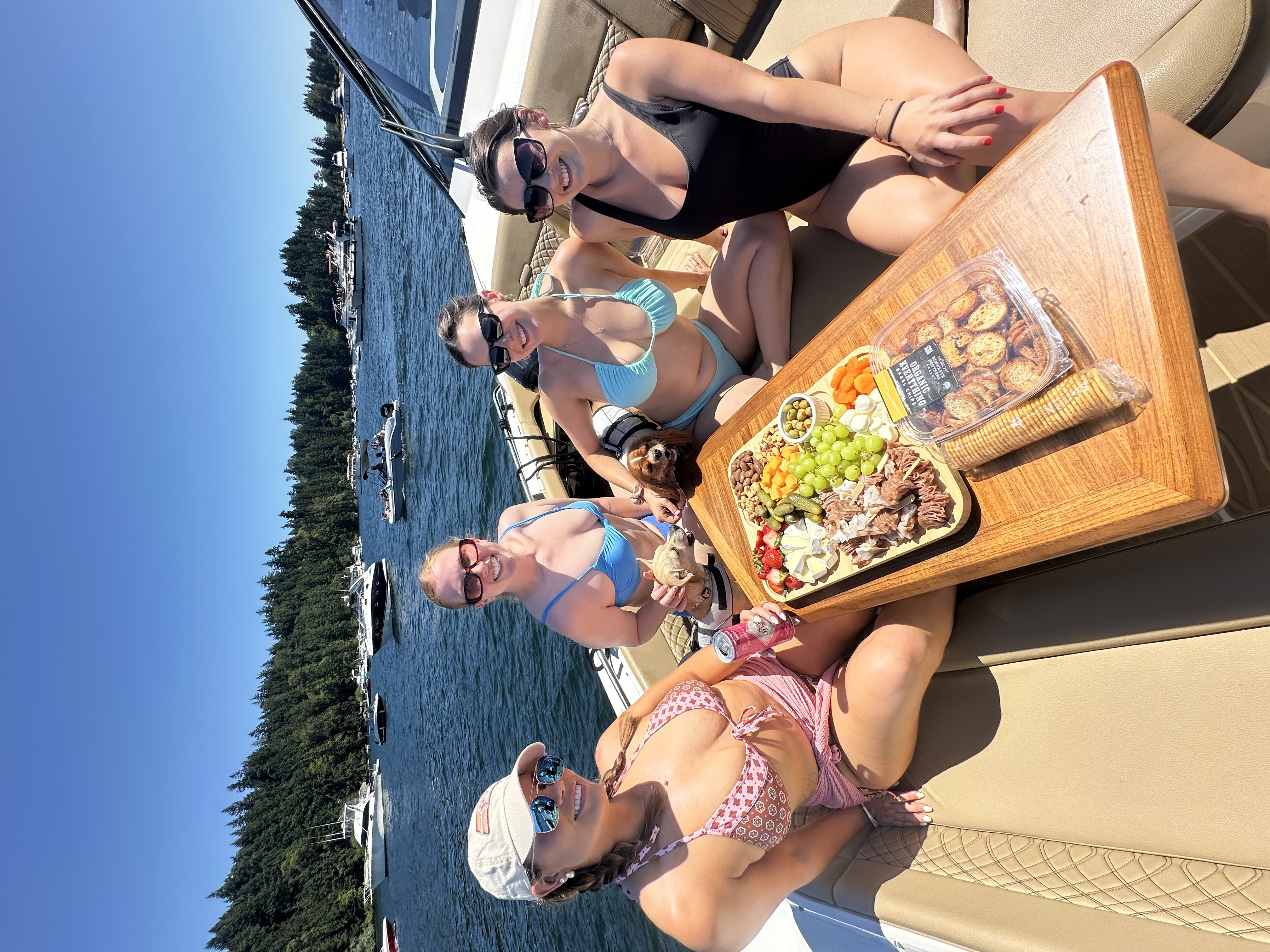 Guests enjoying charcuterie on the bow on Lake Washington